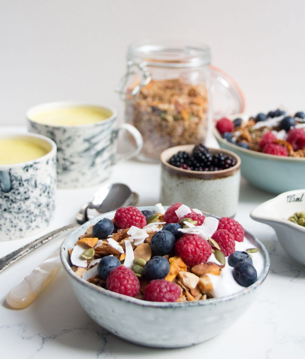 Bowls of yoghurt, granola and berries