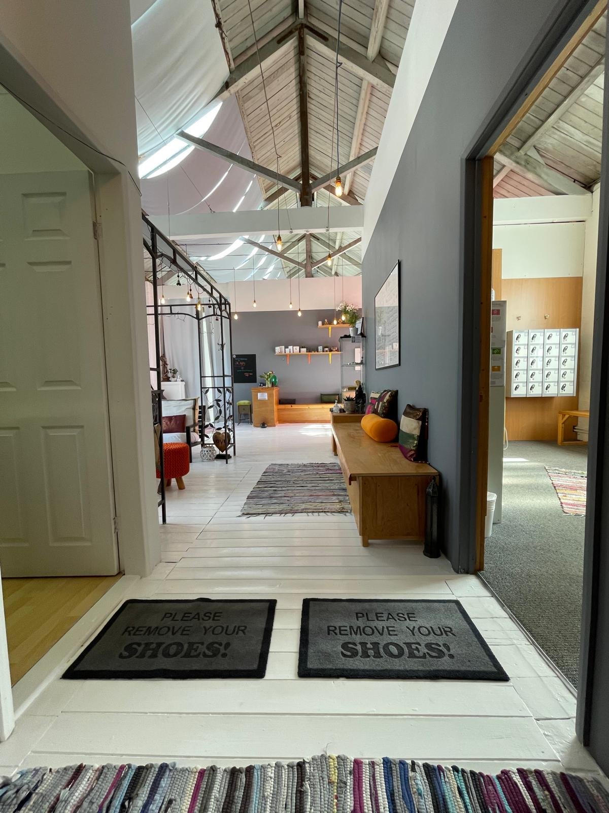 The top-floor entrance, with "Please remove your shoes" mats and the lounge beyond